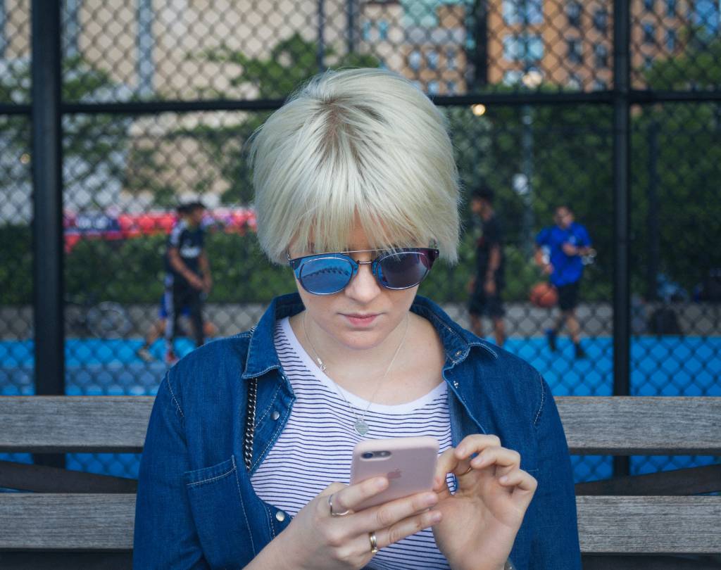 A young woman on her smartphone - showcasing that the younger genration is spending over 10 hours a day on digital devices