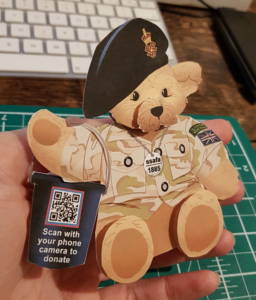 A photo of the SSAFA bear illustration printed out, constructed in miniature